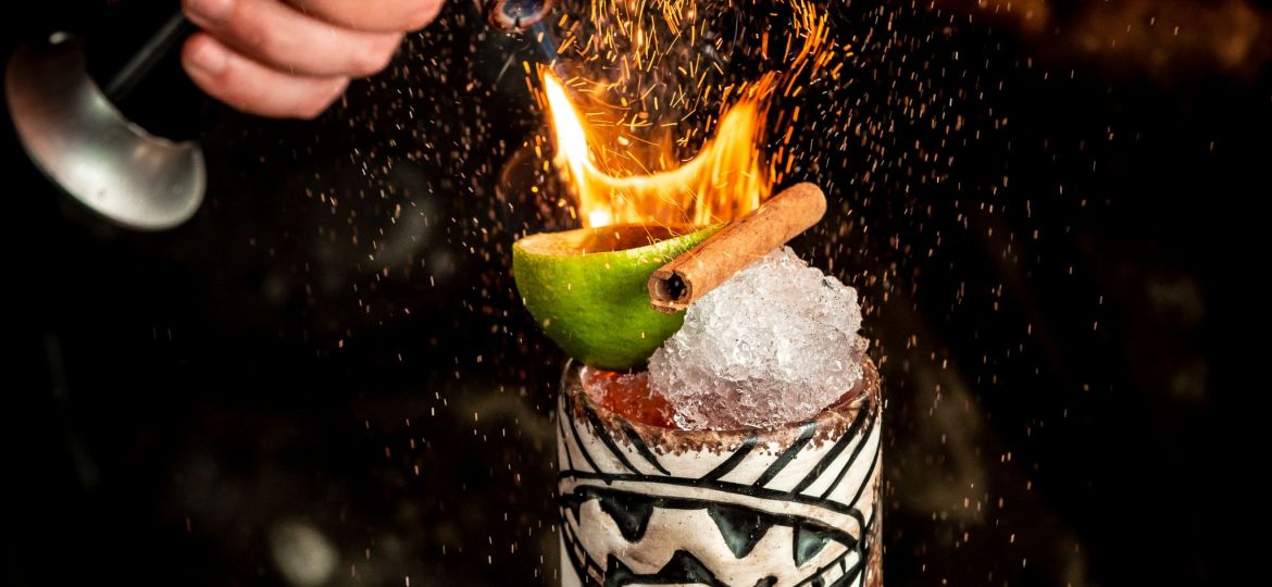 flamed cocktail with ice and fruits
